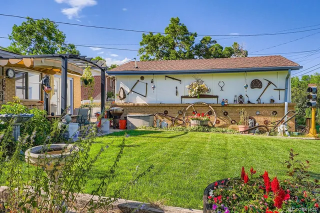 a view of a patio with table and chairs under an umbrella