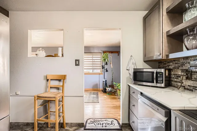 a kitchen with stainless steel appliances kitchen island granite countertop a stove a sink and a microwave