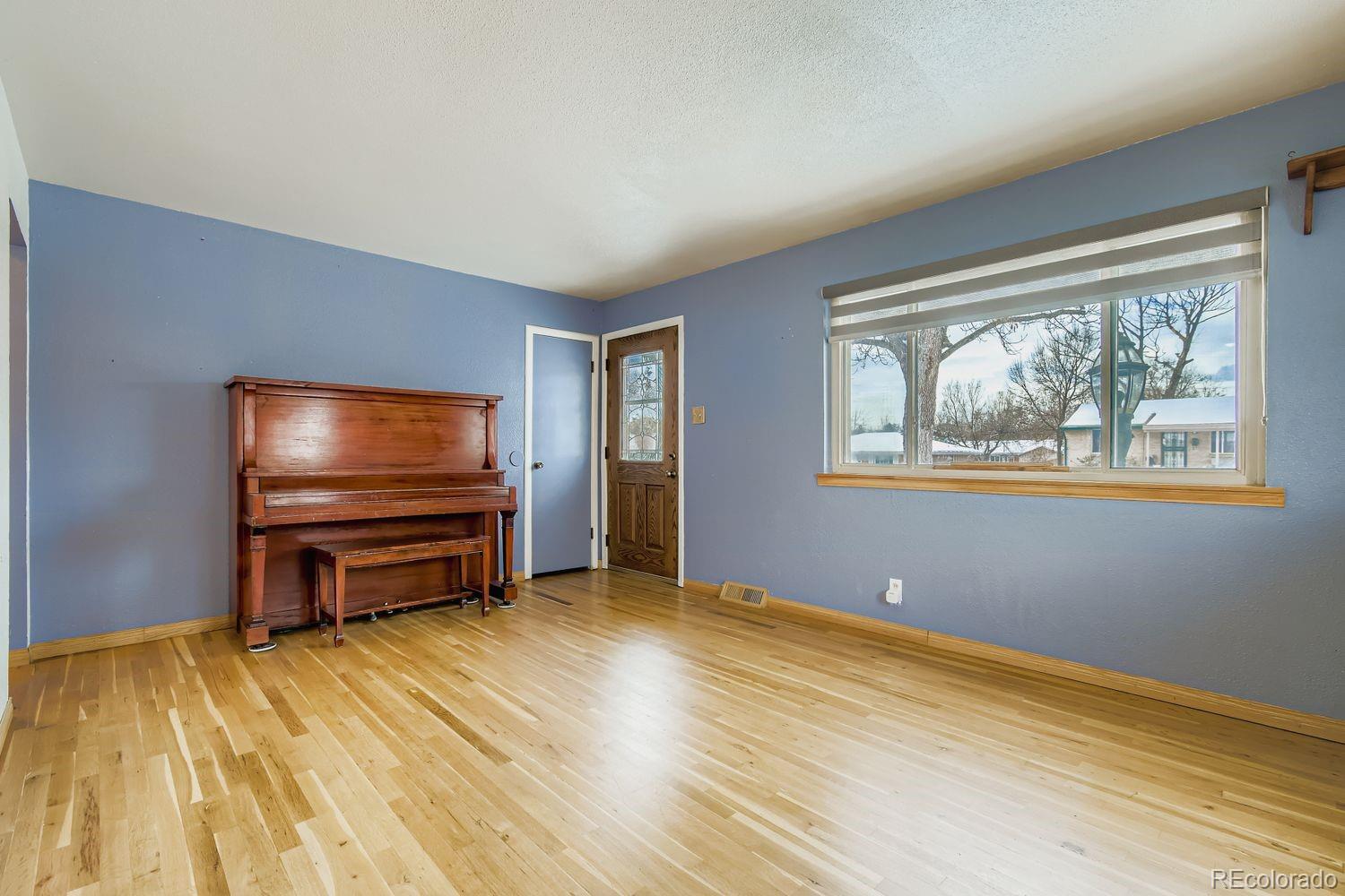 8510 Faraday Street Denver, CO 80229 - Photo 6 of 25 a room with furniture and a flat screen tv