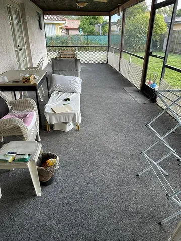 a utility room with furniture and a floor to ceiling window