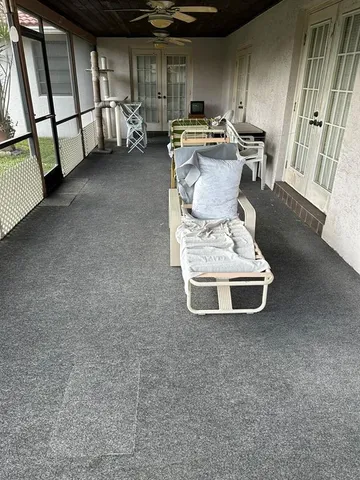 a view of a house with a yard and potted plants