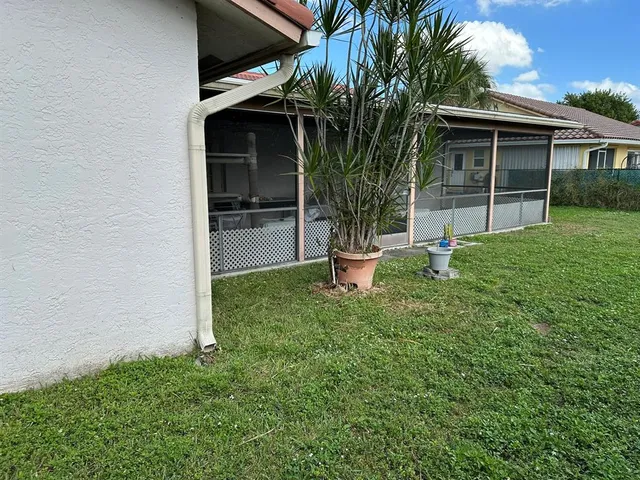 a view of a backyard with plants and a patio
