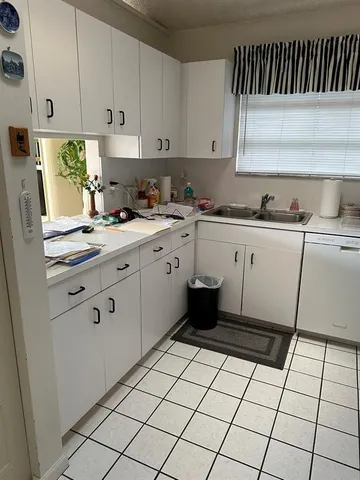 a kitchen with a cabinets a sink and a stove top oven
