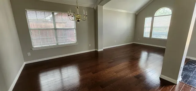 an entryway in a hall with wooden floor