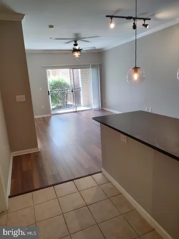 a view of a livingroom with a ceiling fan and window