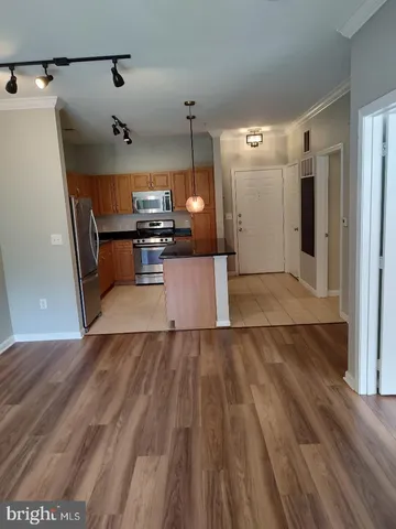 a view of a kitchen with a sink and a refrigerator