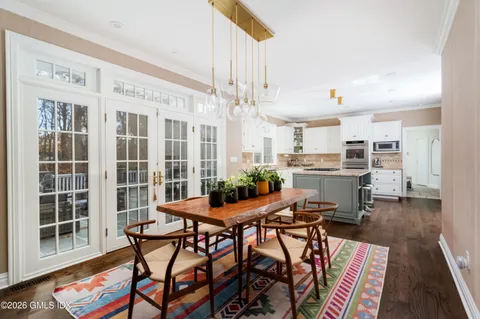 a view of a dining room with furniture and wooden floor