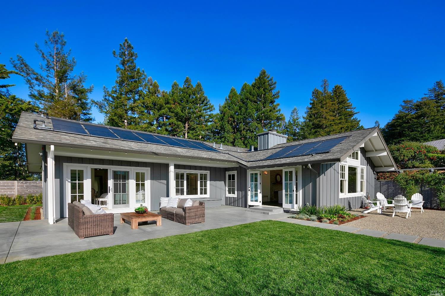 a front view of a house with patio and garden