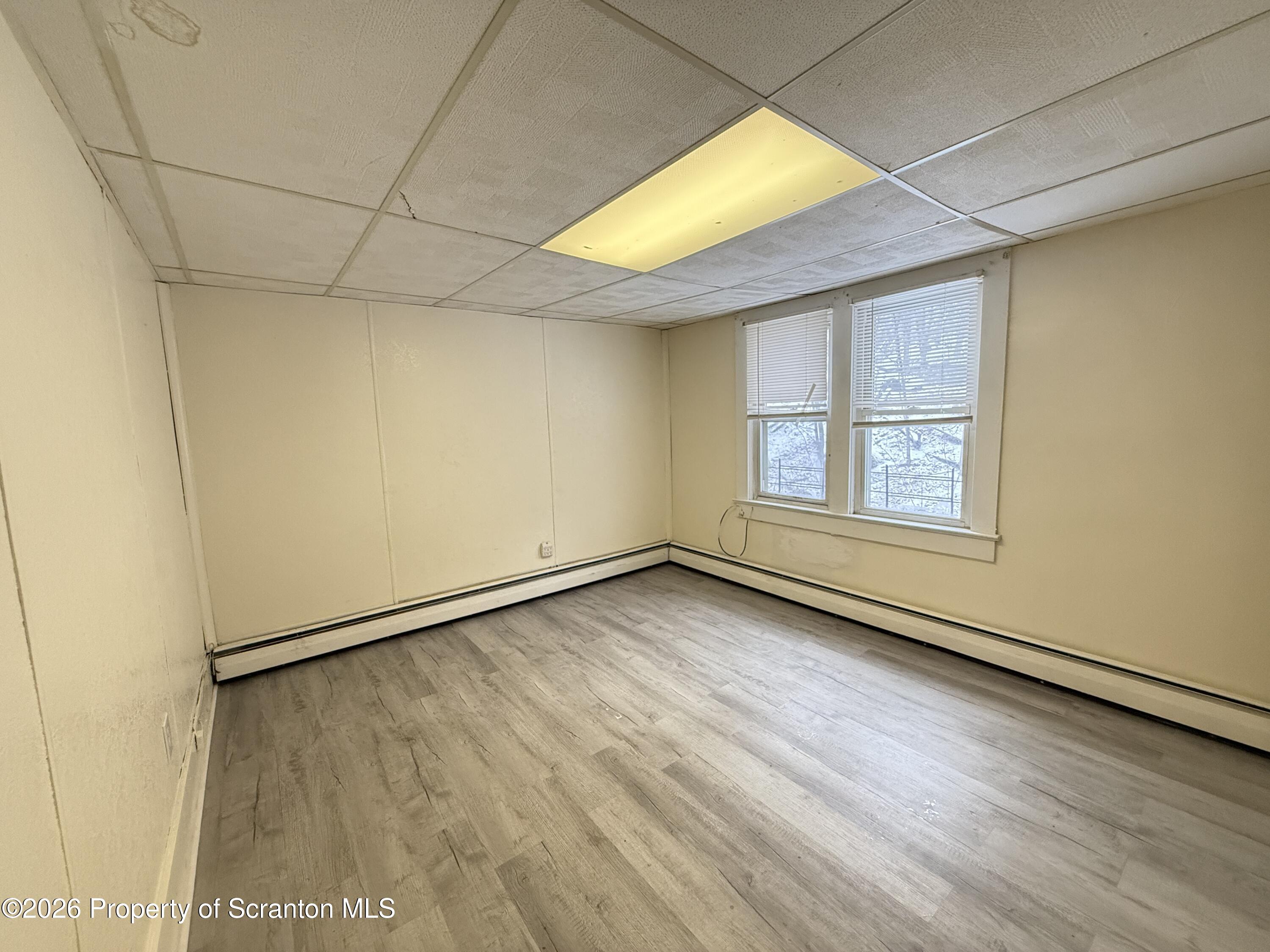 2140 Pond Avenue Scranton, PA 18508 - Photo 13 of 16 an empty room with wooden floor and windows