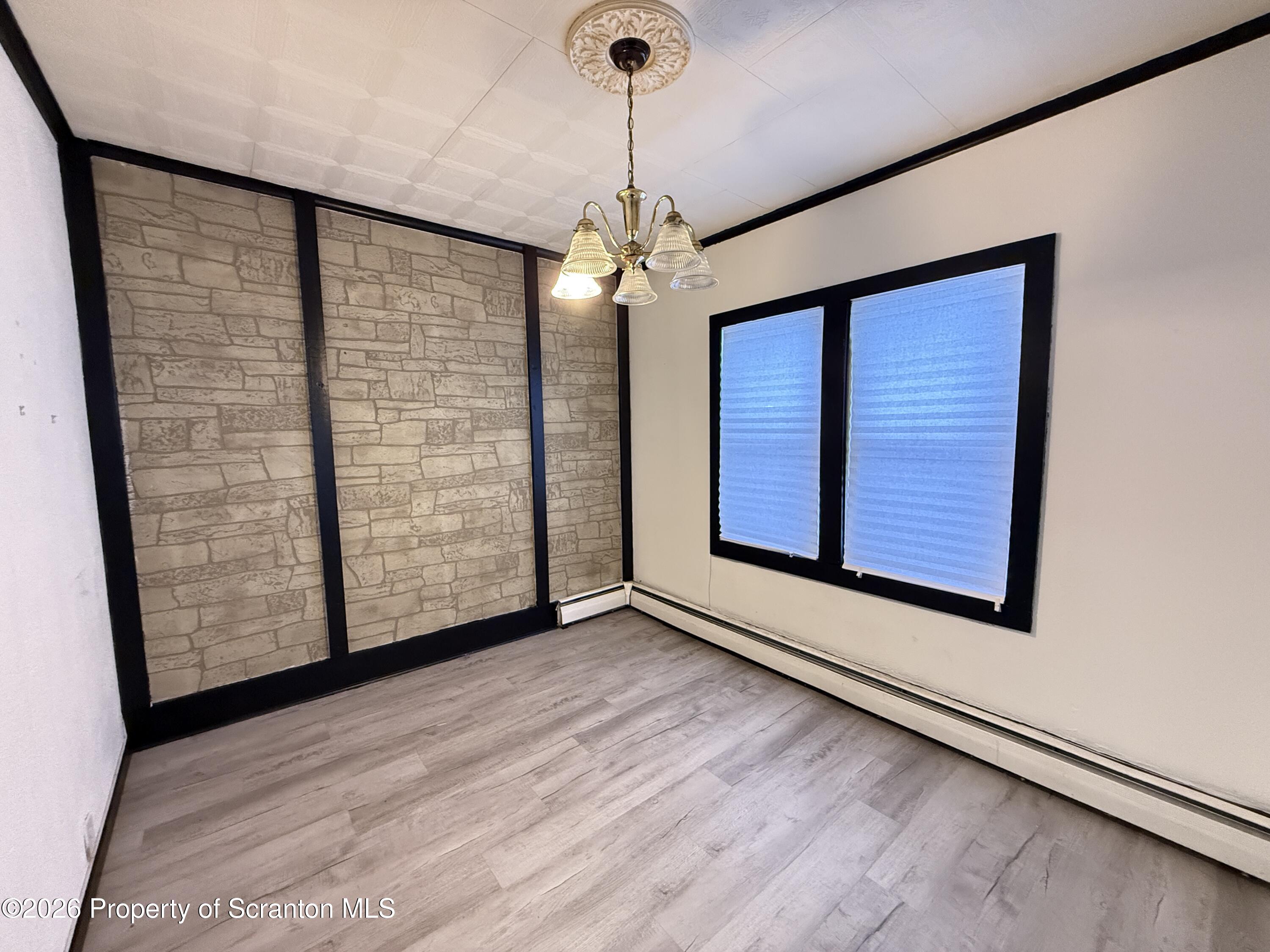 2140 Pond Avenue Scranton, PA 18508 - Photo 7 of 16 a view of an empty room with window and wooden floor