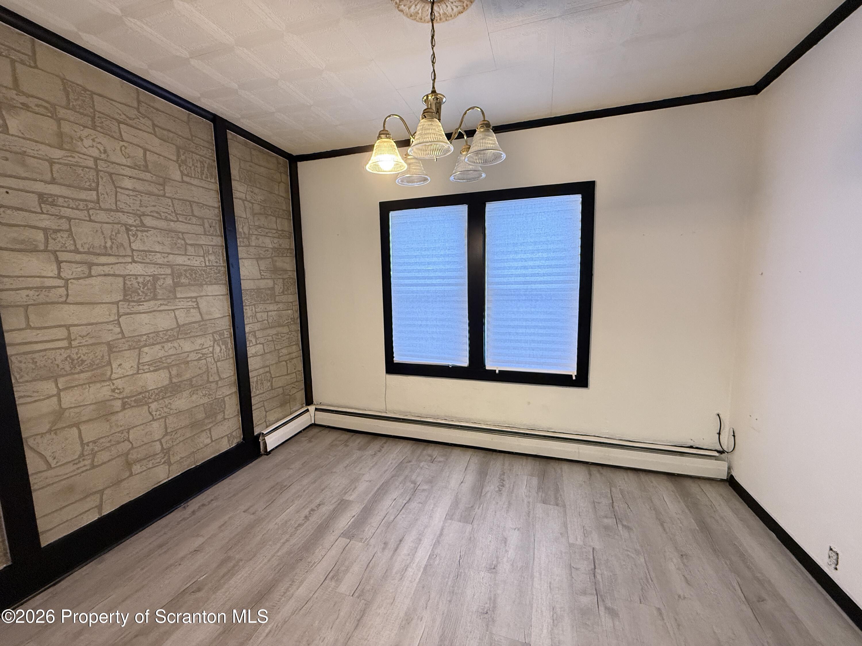2140 Pond Avenue Scranton, PA 18508 - Photo 8 of 16 a view of an empty room with wooden floor and a window