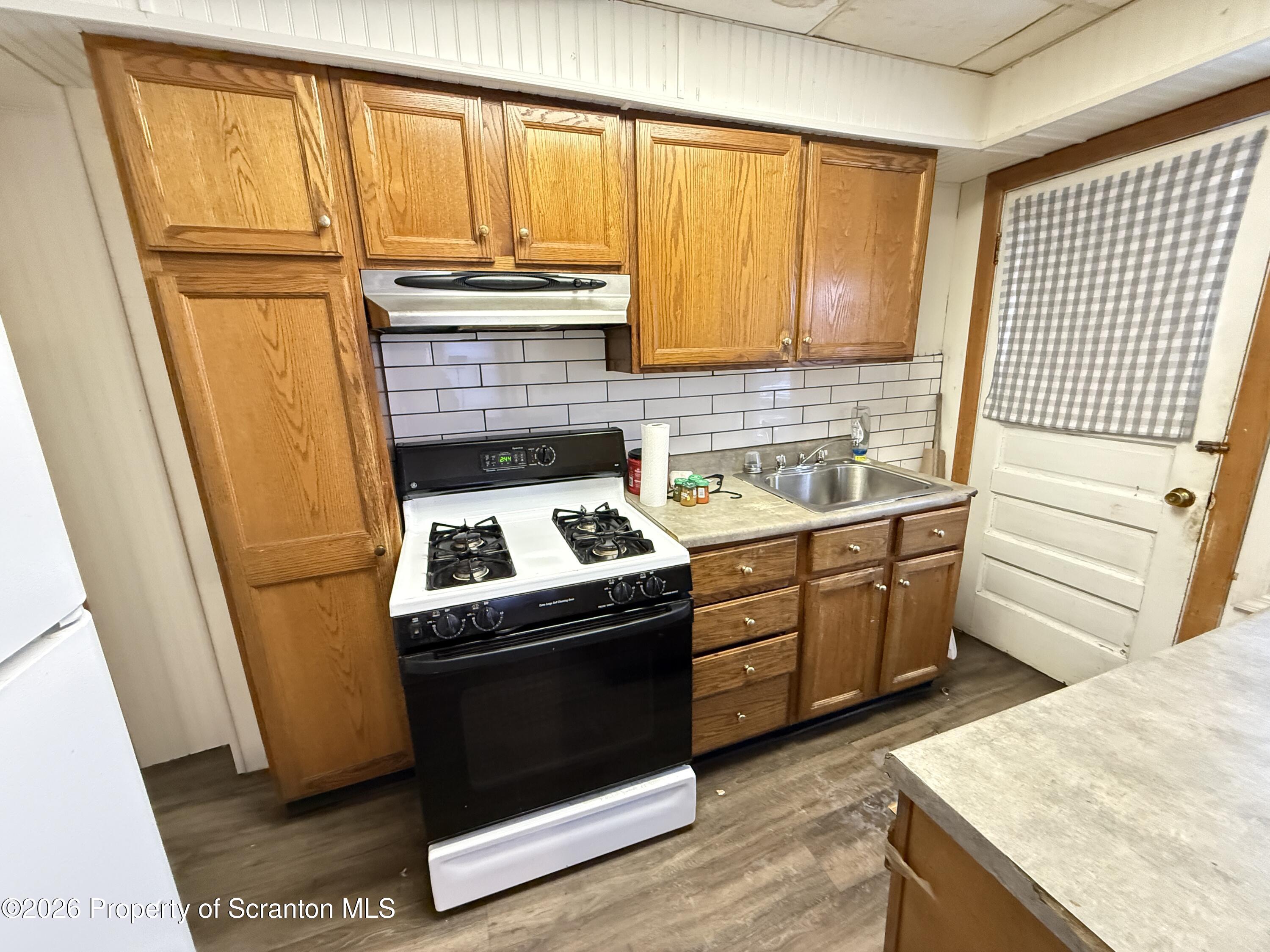 2140 Pond Avenue Scranton, PA 18508 - Photo 9 of 16 a kitchen with a stove a sink and a refrigerator