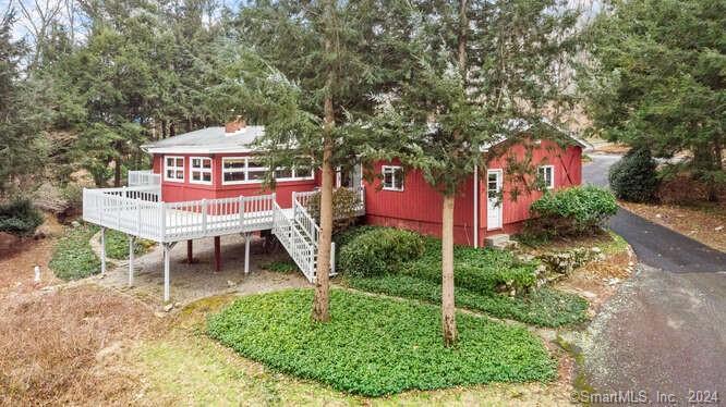 a front view of a house with a yard table and chairs