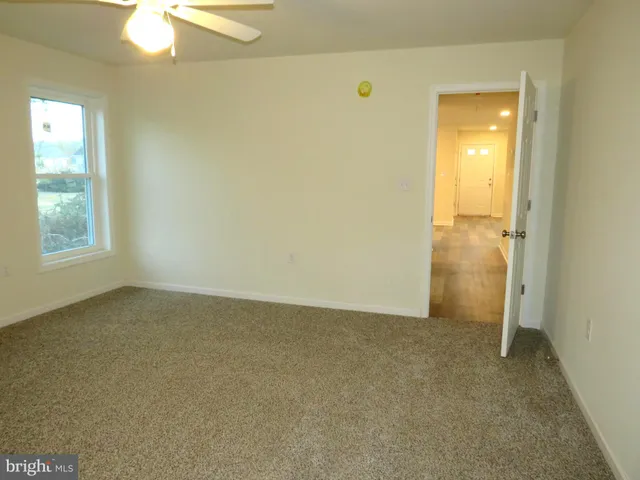an empty room with windows and entrance