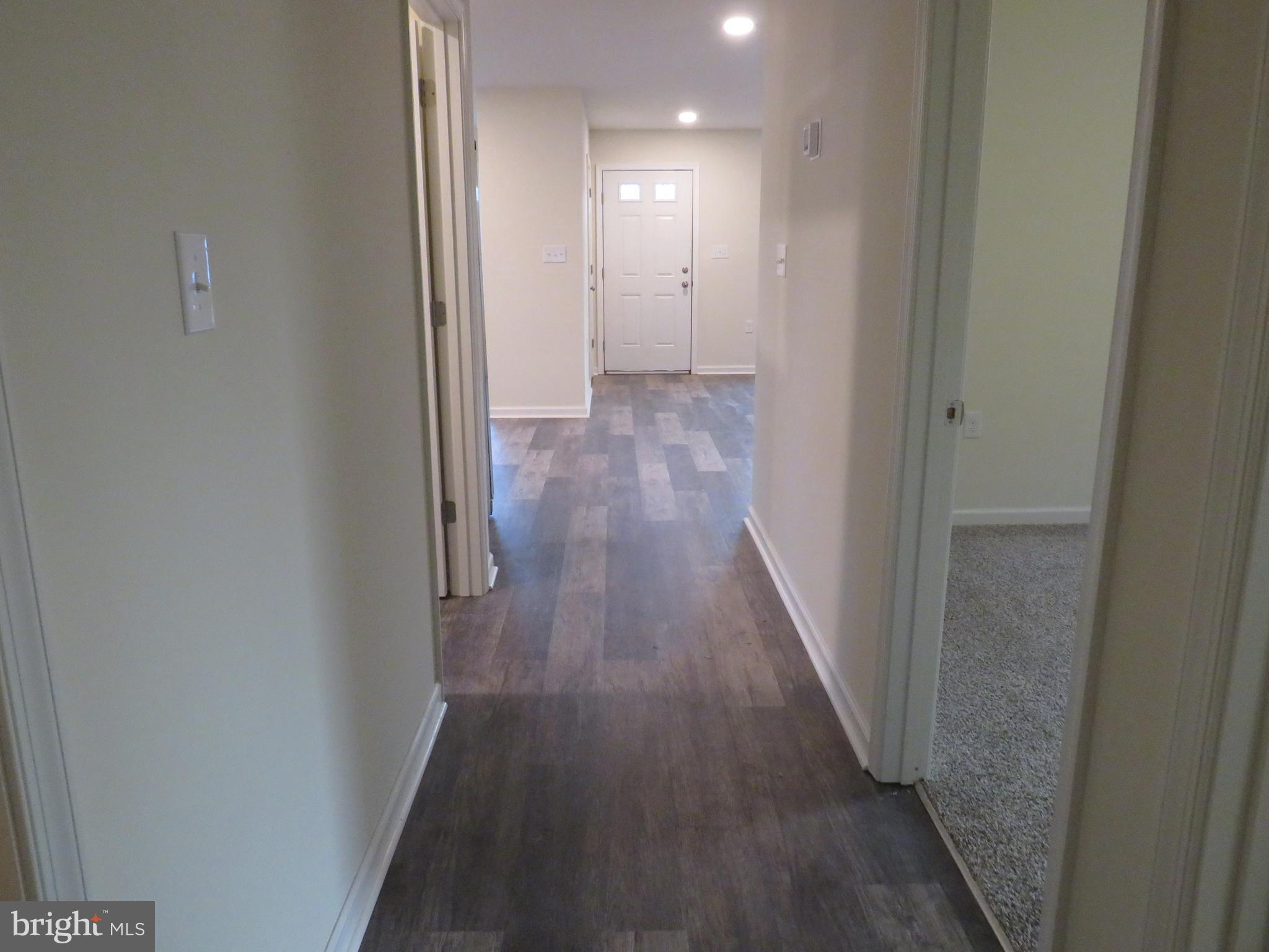 26350 East Pear Street Crisfield, MD 21817 - Photo 22 of 22 a view of a hallway with wooden floor