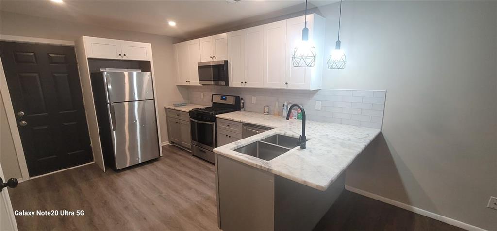 1009 Fairburn Road Northwest Atlanta, GA 30331 - Photo 7 of 15 a kitchen that has a microwave a sink and a refrigerator
