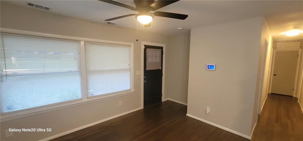 1009 Fairburn Road Northwest Atlanta, GA 30331 - Photo 8 of 15 a view of an empty room with wooden floor and a window