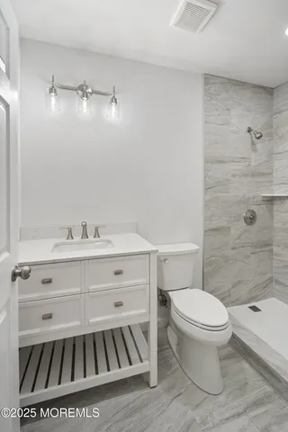 a bathroom with a sink toilet and shower