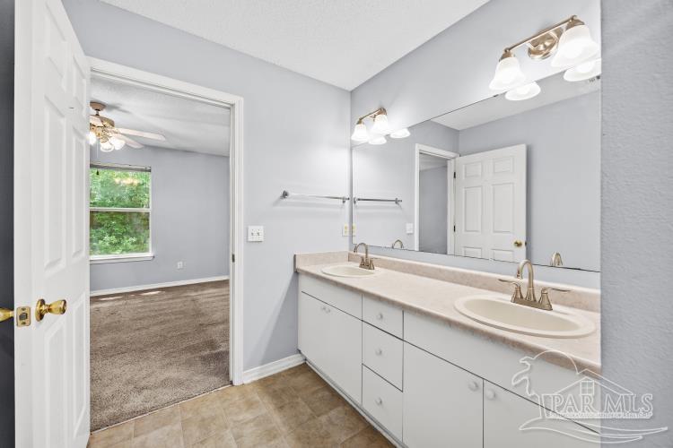 1009 Simpson Street Pensacola, FL 32526 - Photo 11 of 18 a bathroom with a double vanity sink and a mirror
