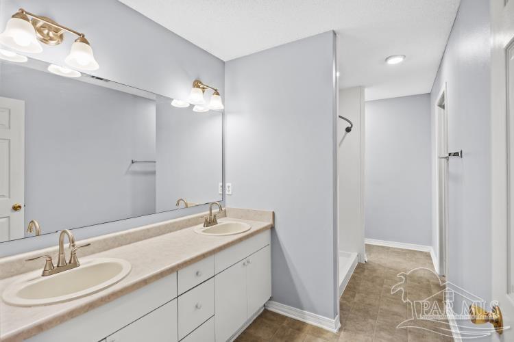 1009 Simpson Street Pensacola, FL 32526 - Photo 12 of 18 a bathroom with a sink and a mirror
