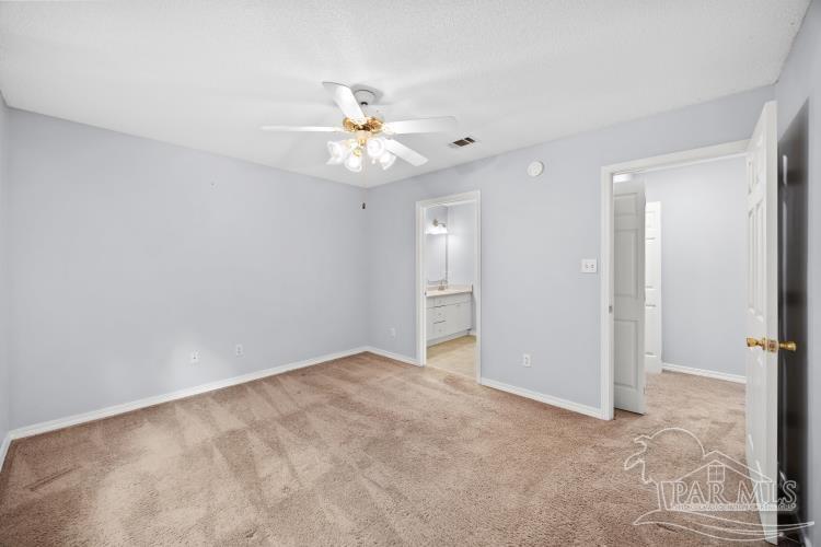 1009 Simpson Street Pensacola, FL 32526 - Photo 17 of 18 an empty room with a ceiling fan and a window