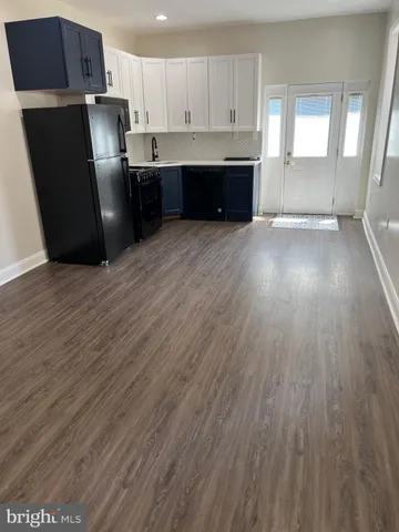 a kitchen with cabinets appliances and a sink