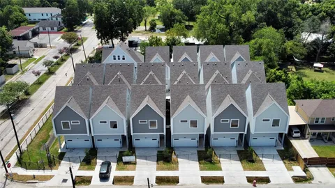 an aerial view of multiple houses with a yard