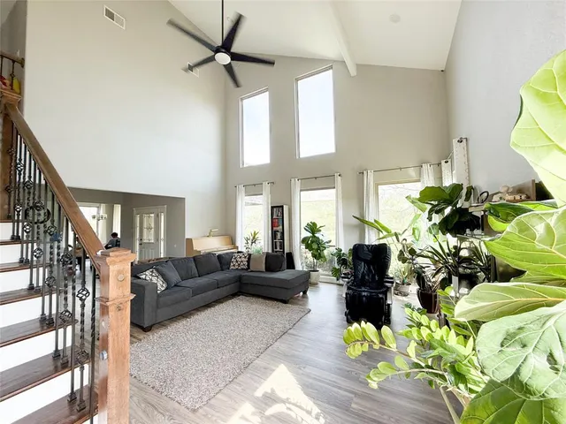 a living room with fireplace furniture and a potted plant