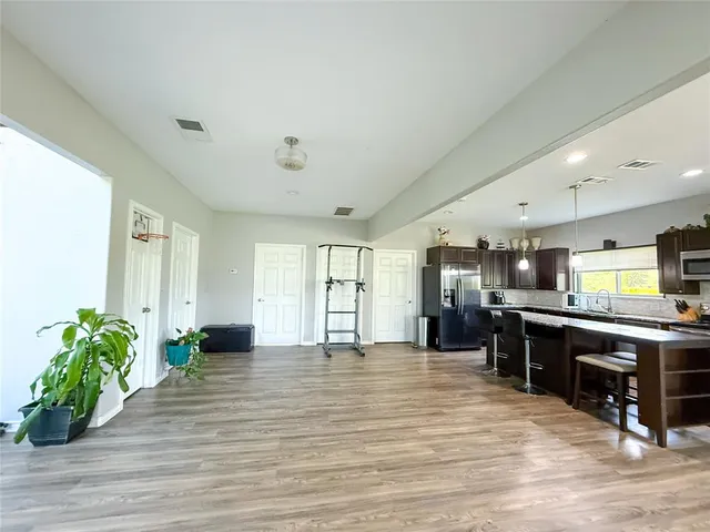 a large kitchen with stainless steel appliances granite countertop a stove refrigerator and a fireplace