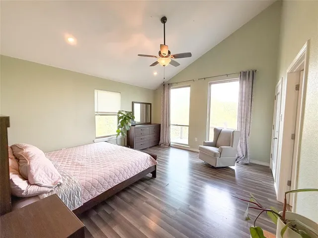 a bedroom with bed couch and window