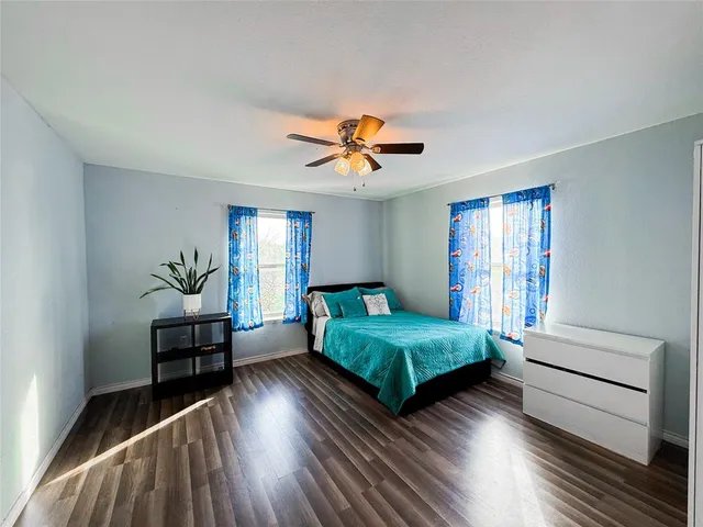 a bedroom with two beds and a chandelier