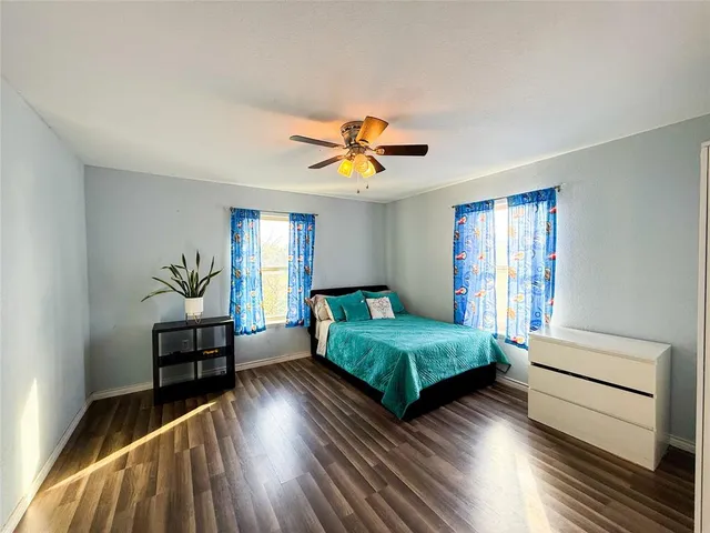 a bedroom with two beds and a window