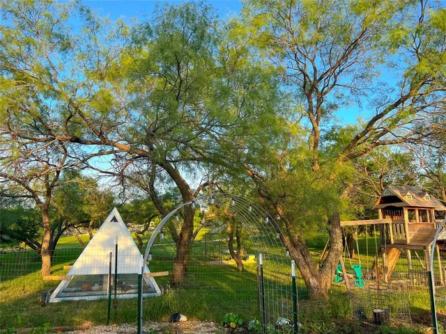 a tent sitting in middle of tall trees