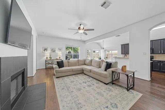 a living room with furniture a fireplace and a flat screen tv