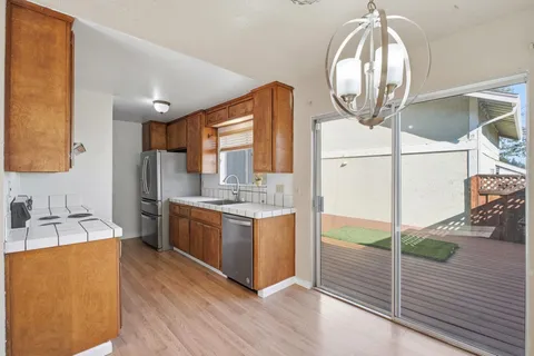 a kitchen with stainless steel appliances granite countertop a stove a sink and a refrigerator