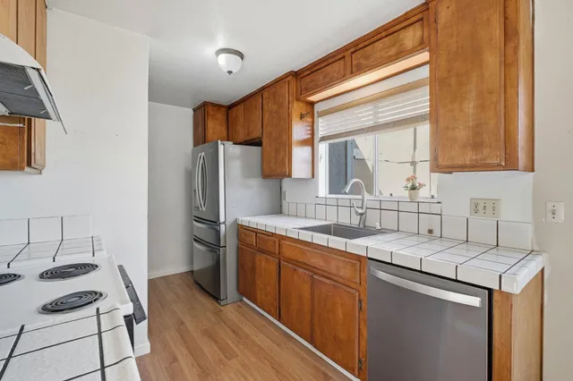 a kitchen with a sink stove and refrigerator