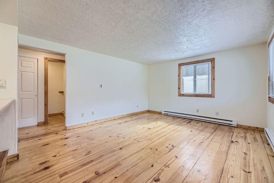 709 Frisco Street, Unit 67 Frisco, CO 80443 - Photo 13 of 27 an empty room with wooden floor and windows