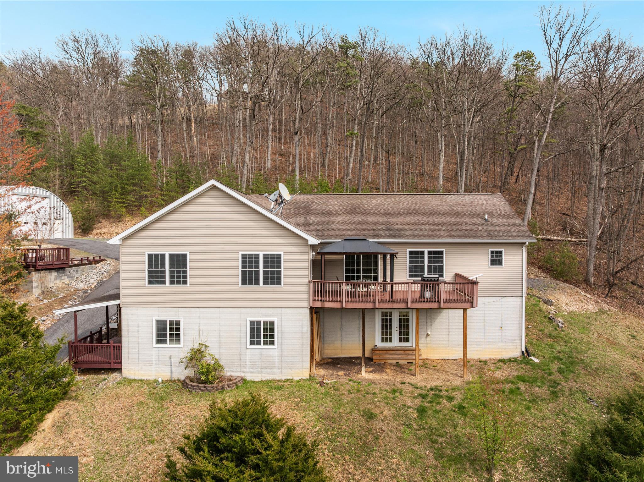 283 Rock Ridge Road Front Royal, VA 22630 - Photo 58 of 64 a front view of a house with a yard and trees