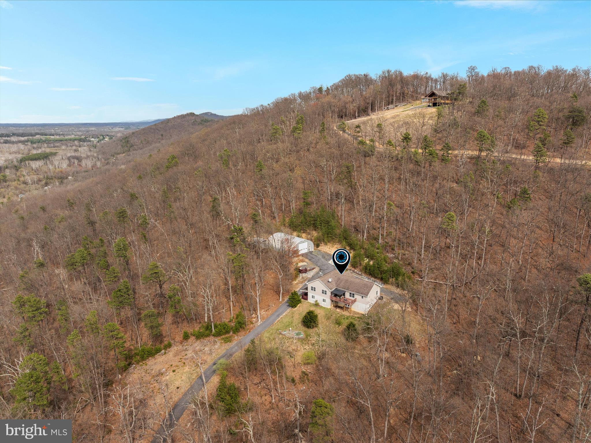 283 Rock Ridge Road Front Royal, VA 22630 - Photo 62 of 64 a view of a dry yard with mountains in the background