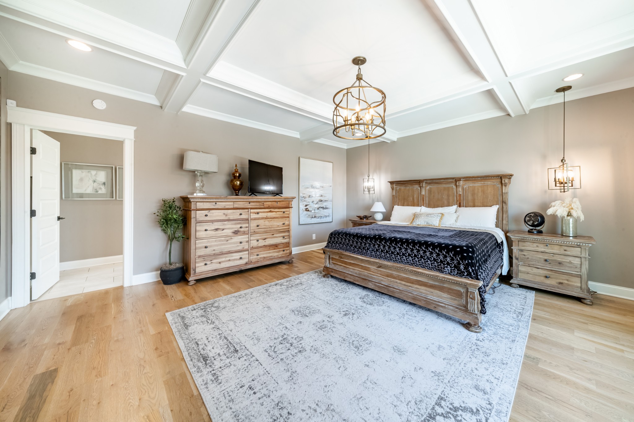 304 Charleston Street Lebanon, TN 37087 - Photo 17 of 51 a spacious bedroom with a bed and a chandelier
