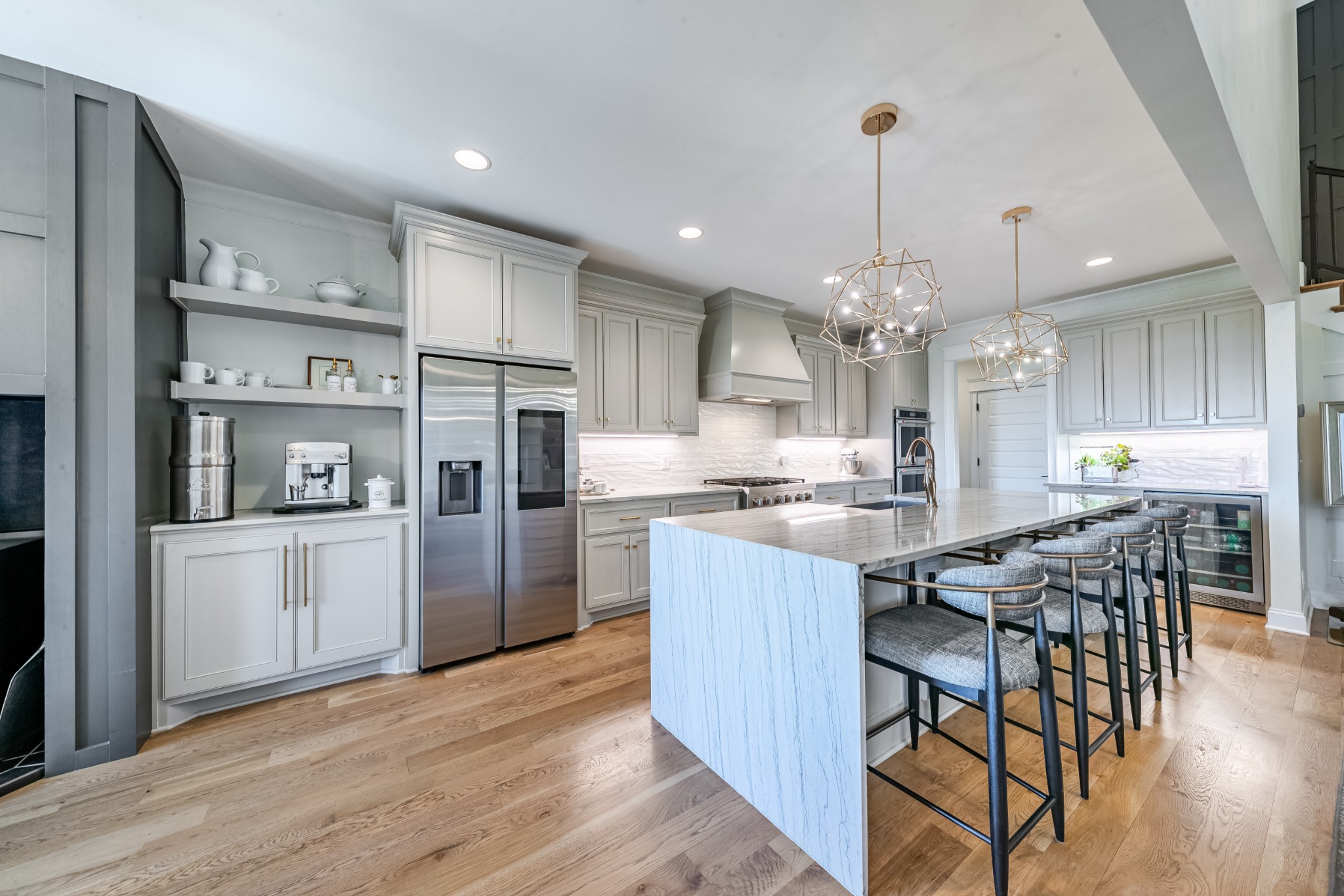 304 Charleston Street Lebanon, TN 37087 - Photo 6 of 51 a kitchen with stainless steel appliances kitchen island granite countertop a refrigerator a stove a sink dishwasher and a dining table with wooden floor