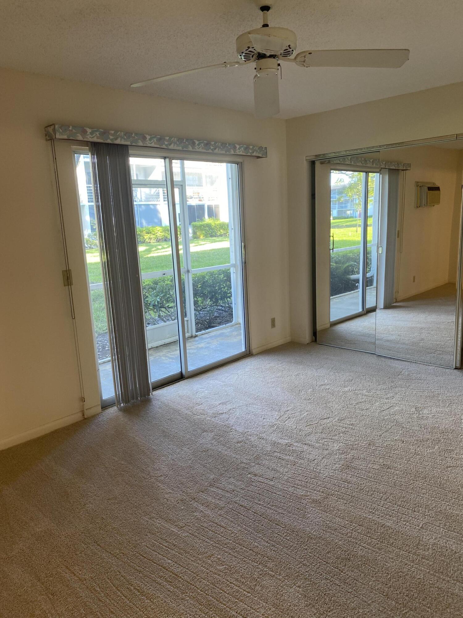 429 Fanshaw North, Unit K Boca Raton, FL 33434 - Photo 7 of 16 a view of an empty room with a window