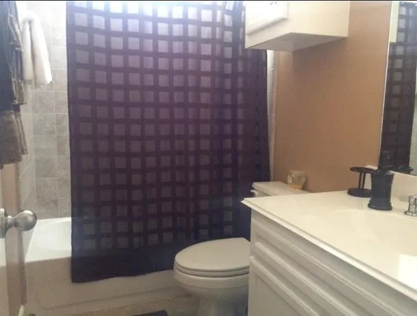 a spacious bathroom with a double vanity sink a mirror and a bathtub