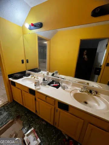 a living room with furniture a flat screen tv and kitchen view