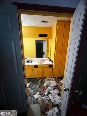 a bed with a pink blanket and pillows