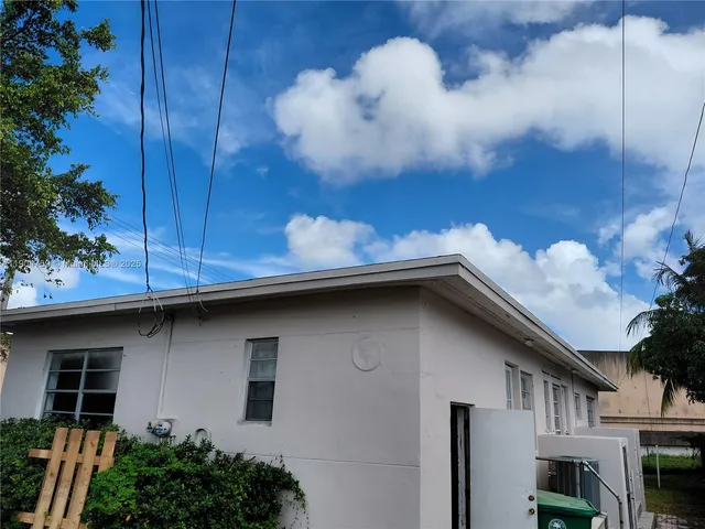 a view of backyard with potted plants