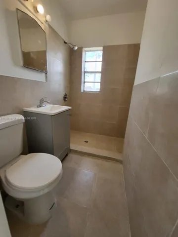 a white toilet sitting next to a bathroom sink