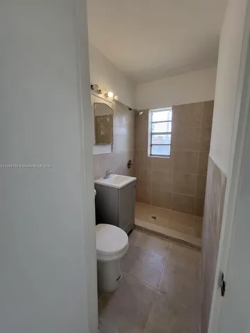a bathroom with a toilet sink and shower