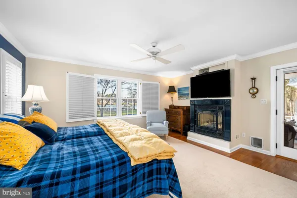 a bedroom with furniture and a large window