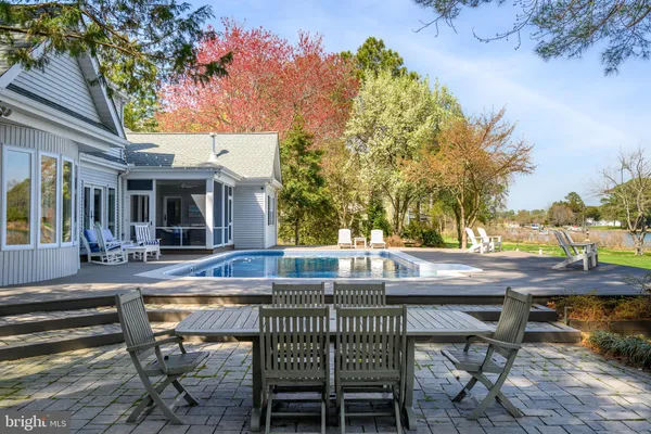 a large kitchen with granite countertop a large counter top a sink stainless steel appliances and windows